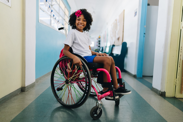 Portrait of a wheelchair girl student at school